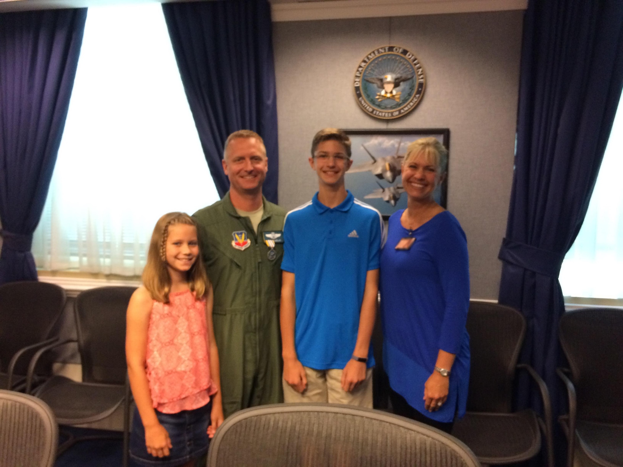 U.S. Air Force Col. Brian Laidlaw, 325th Fighter Wing vice wing commander, and his family pose for a family photo in a conference room in the Pentagon, Washington D.C.