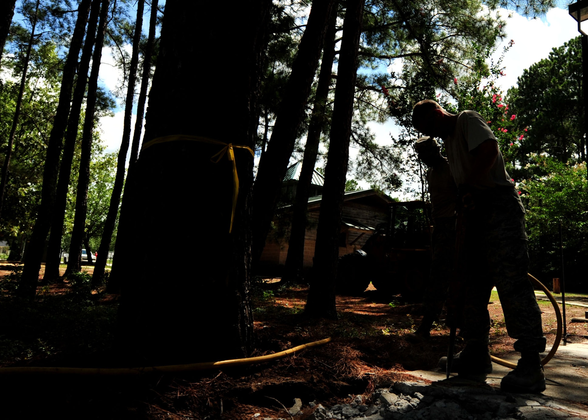 U.S. Airmen assigned to the 20th Civil Engineer Squadron worked as a team to demolish an uneven concrete sidewalk upheaved by tree roots at Shaw Air Force Base, S.C., Aug. 10, 2017. The pavement and construction equipment Airmen,  also known as “Dirt Boyz,” used tools such as a pneumatic 30-pound jack hammer and pickaxe to remove approximately five cubic yards of concrete to make way for a new path. (U.S. Air Force photos by Airman 1st Class Kathryn R.C. Reaves)