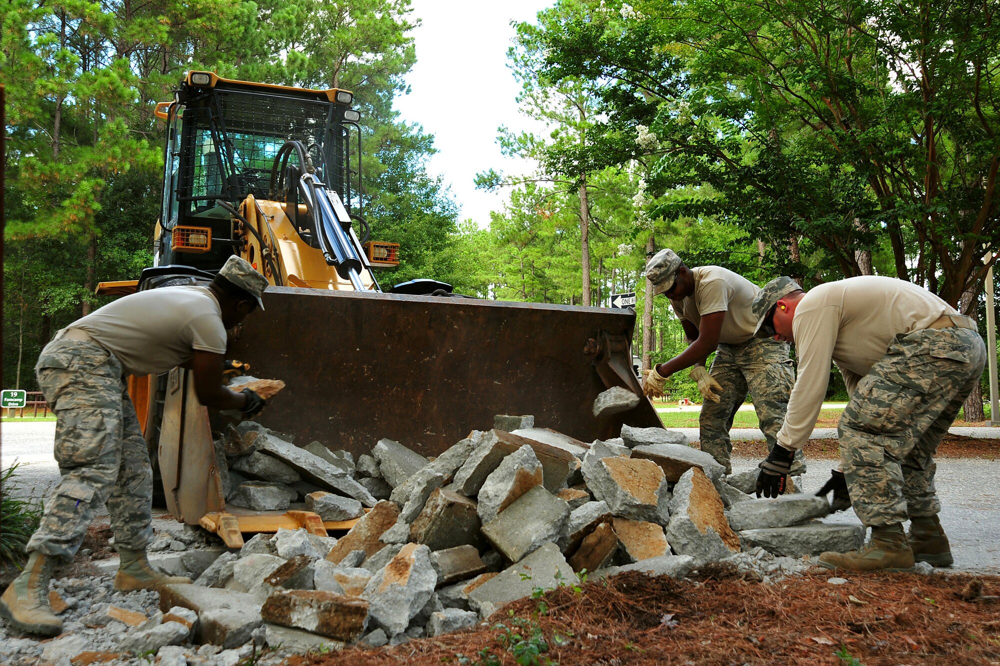 U.S. Airmen assigned to the 20th Civil Engineer Squadron worked as a team to demolish an uneven concrete sidewalk upheaved by tree roots at Shaw Air Force Base, S.C., Aug. 10, 2017. The pavement and construction equipment Airmen,  also known as “Dirt Boyz,” used tools such as a pneumatic 30-pound jack hammer and pickaxe to remove approximately five cubic yards of concrete to make way for a new path. (U.S. Air Force photos by Airman 1st Class Kathryn R.C. Reaves)