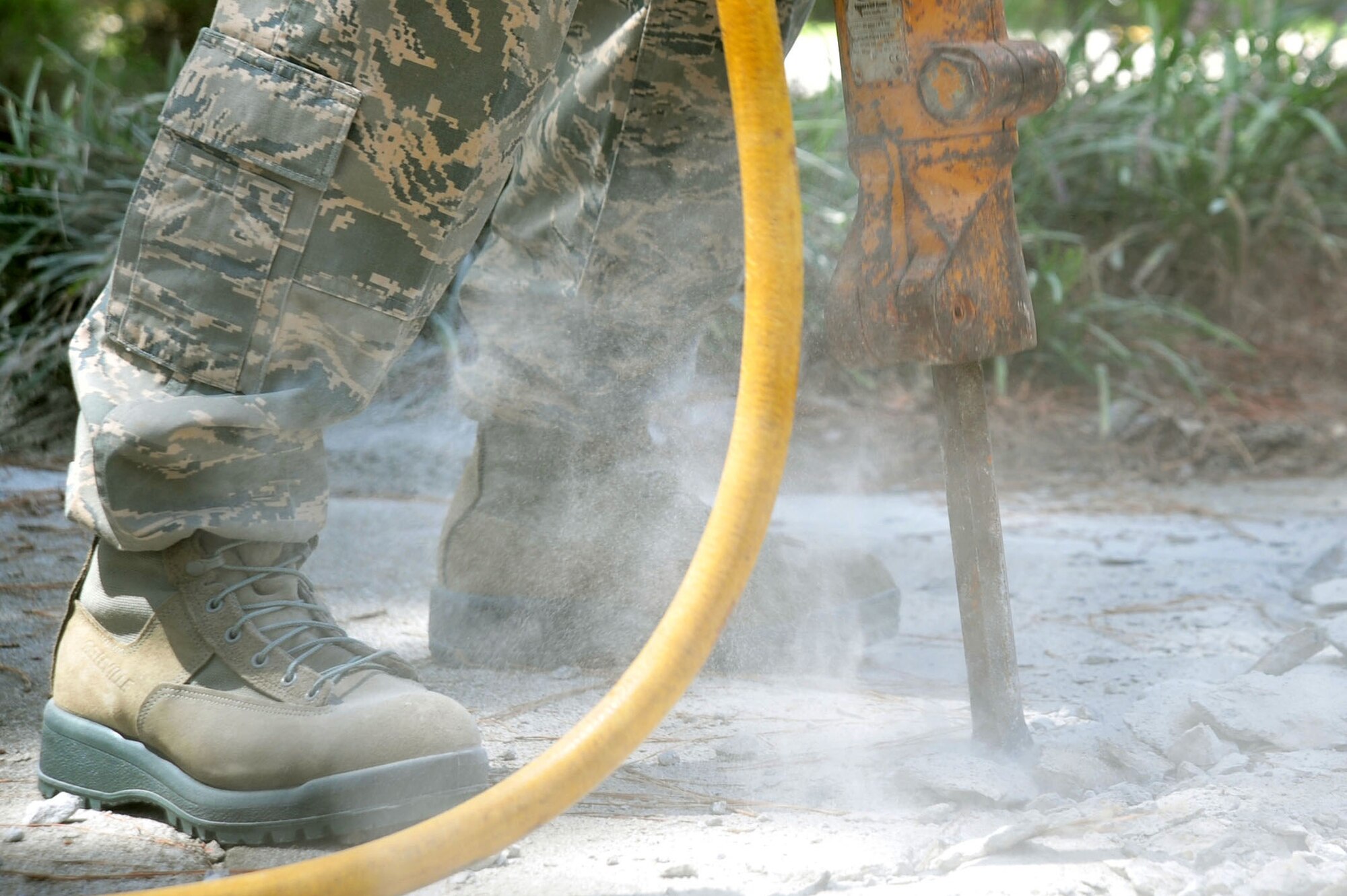 U.S. Airmen assigned to the 20th Civil Engineer Squadron worked as a team to demolish an uneven concrete sidewalk upheaved by tree roots at Shaw Air Force Base, S.C., Aug. 10, 2017. The pavement and construction equipment Airmen,  also known as “Dirt Boyz,” used tools such as a pneumatic 30-pound jack hammer and pickaxe to remove approximately five cubic yards of concrete to make way for a new path. (U.S. Air Force photos by Airman 1st Class Kathryn R.C. Reaves)