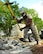 U.S. Airmen assigned to the 20th Civil Engineer Squadron worked as a team to demolish an uneven concrete sidewalk upheaved by tree roots at Shaw Air Force Base, S.C., Aug. 10, 2017. The pavement and construction equipment Airmen,  also known as “Dirt Boyz,” used tools such as a pneumatic 30-pound jack hammer and pickaxe to remove approximately five cubic yards of concrete to make way for a new path. (U.S. Air Force photos by Airman 1st Class Kathryn R.C. Reaves)