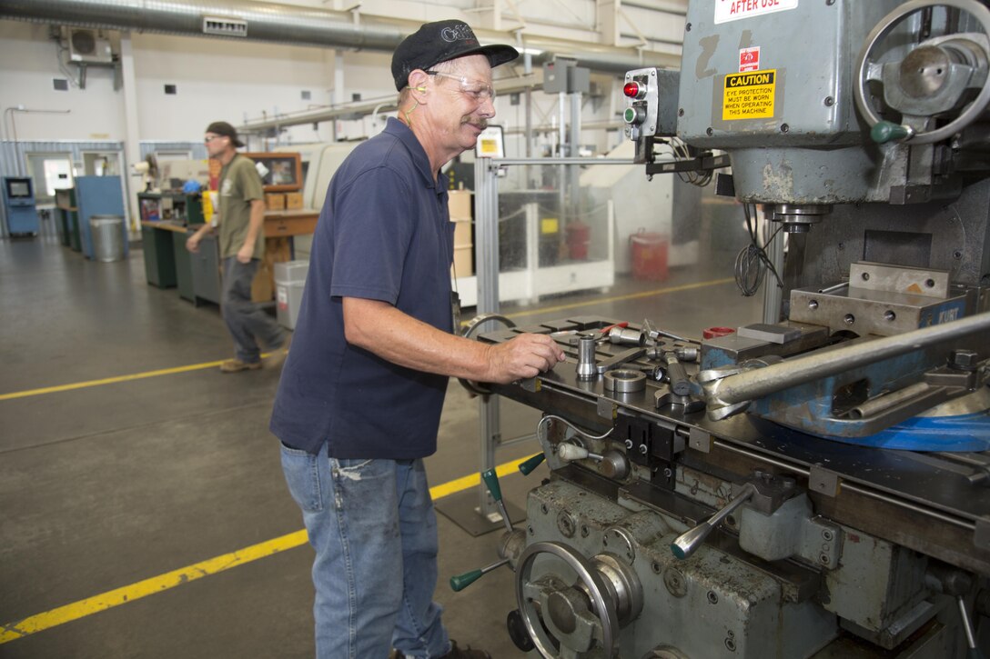Richard Ristow works on a vertical milling machine to design parts for a special stand to be used to support the Cougar variant of the MRAP so that mechanics can safely work on it, Aug. 2. Ristow has 35 years of experience as a machinist, a large part of that at Production Plant Barstow, Marine Depot Maintenance Command, aboard the Yermo Annex of Marine Corps Logistics Base Barstow, Calif.