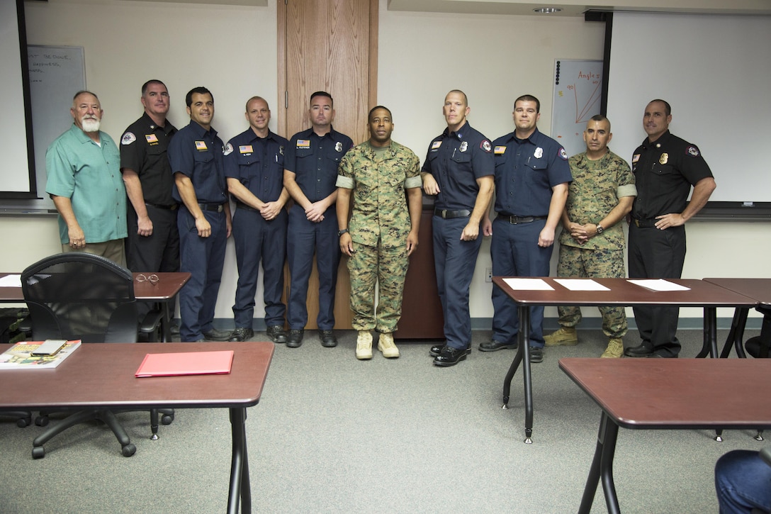 Danny Strand, director, Security and Emergency Services, Marine Corps Logistics Base Barstow, Calif.; Gregg Kunkel, chief, emergency medical services; Zachary Zamora, firefighter, Eric Keck, paramedic, James Fletcher, firefighter, Col. Sekou Karega, commanding officer, MCLBB; Capt. Marvin Torgeson, Kevin Watson, firefighter  Sgt.Maj. Sergio MartinezRuiz, base sergeant major, and Paul Purdy, chief, MCLBB FD; assembled to recognize six firefighters for their actions to save a man trapped between two military vehicles at Fleet Support Division Oct. 25, 2016. Thanks to their quick actions the man survived, but had to have his right kidney removed.