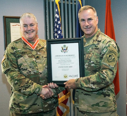 Col. John Hurley, U.S. Army Engineering and Support Center commander, presents Lt. Col. Burlin Emery, Huntsville Center deputy commander, with a certificate of retirement during a ceremony at the Center Aug. 11.