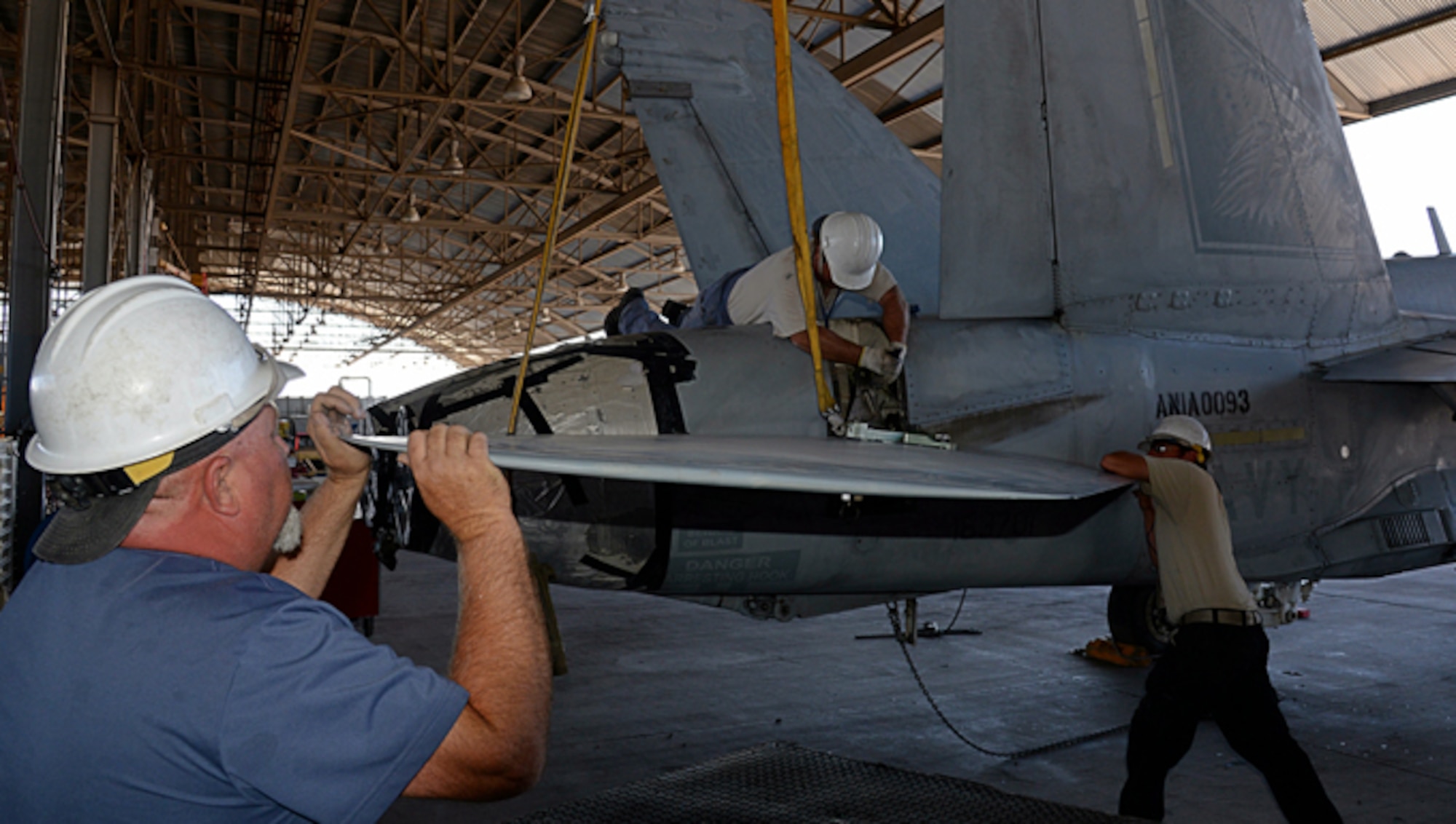 309th Aerospace Maintenance and Regeneration Group mechanics work to remove a stabilator from an F/A-18C Hornet at Davis-Monthan AFB, Ariz., on June 6, 2016, in preparation for the aircraft to be transported to a Boeing maintenance facility at Cecil Airport in Jacksonville, Fla.