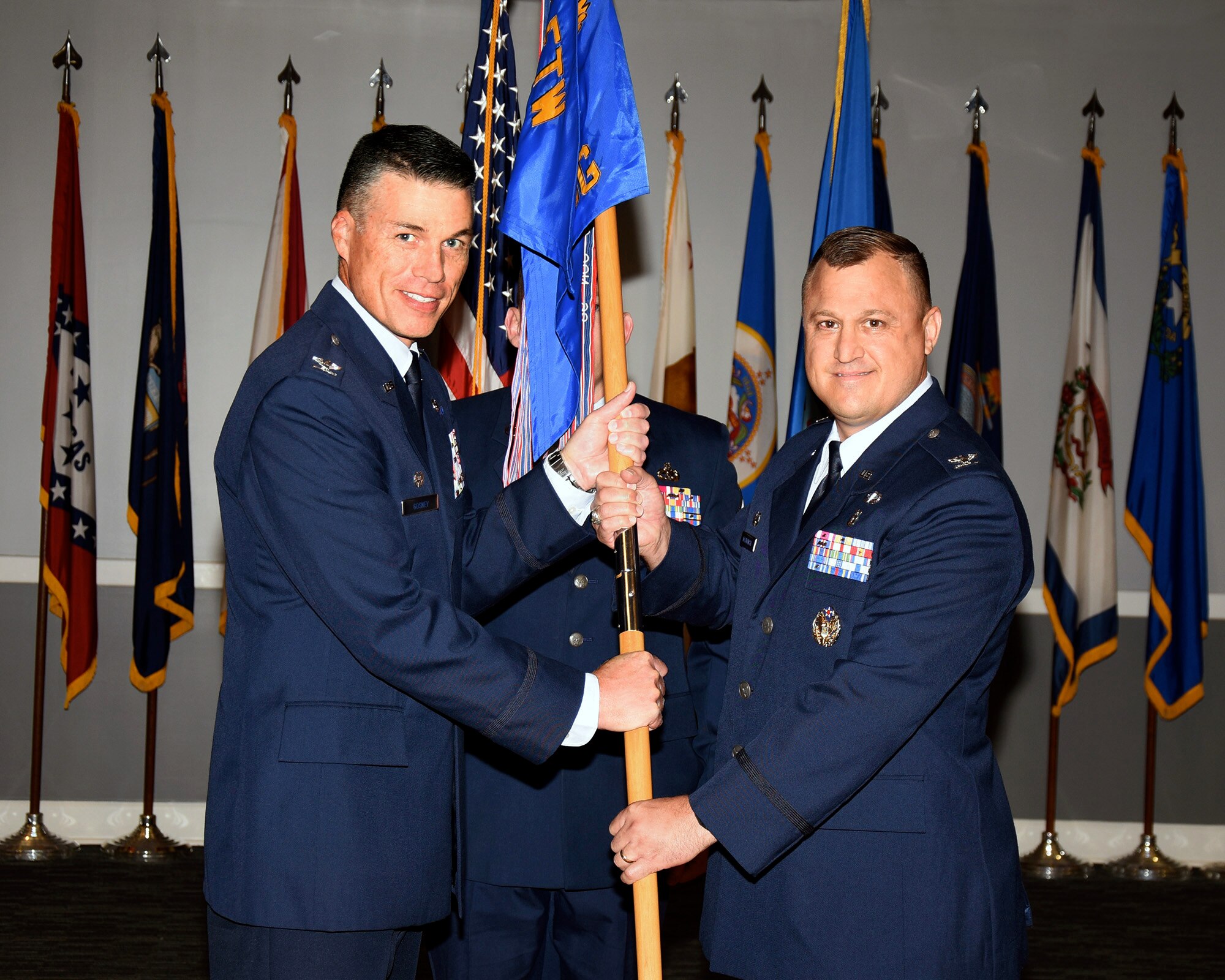 Col. Douglas Gosney, 14th Flying Training Wing Commander, passes the 14th Medical Group guidon to Col. Guy Majkowski, the new 14th MDG Commander. Majkowski's was the Commander of the 48th Medical Operations Squadron at Royal Air Force Lakenheath, United Kingdom. (U.S. Air Force photo by Sharon Ybarra)