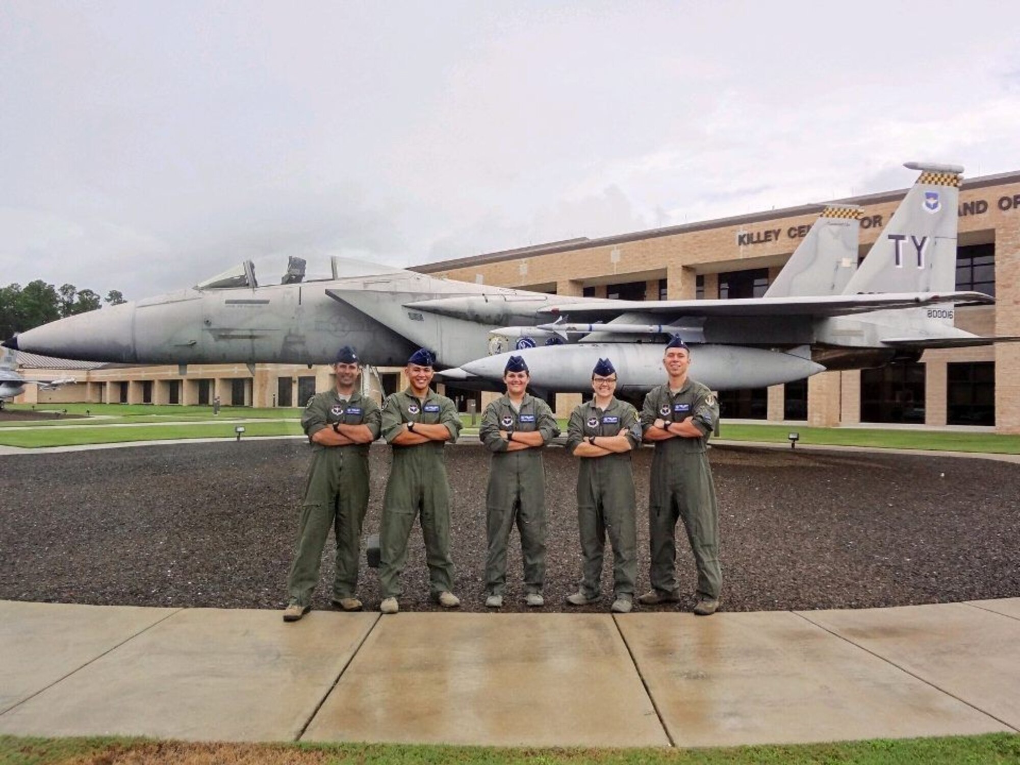 Graduating Air Battle Manager Class 17011 stand in front of the Killey Center for Homeland Operations for a group photo at Tyndall Air Force Base, Fla. The five graduates will move to combat ready air force squadrons to provide command and control mission execution as Air Battle Managers in a variety of weapons systems in support of air expeditionary forces worldwide.