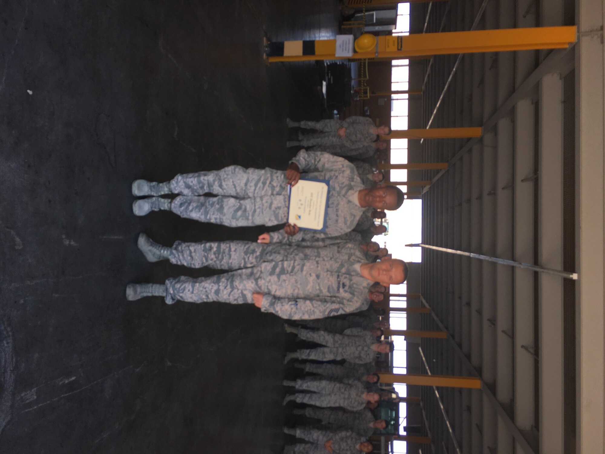 Airman 1st Class Brandon Butts, a 635th Materiel Maintenance Support Squadron mobility readiness spare package apprentice, receives the Top III Airman award from Master Sgt. William Wallick, the 54th Aircraft Maintenance Squadron first sergeant, Aug. 2, 2017, at Holloman Air Force Base, N.M. Butts helped identify 400 expired items, coordinated with equipment custodians for local disposal, and established replacement items worth $12K. He assisted with the transfer of 40,000 assets between equipment custodians for war plans additive plans requirement. Additionally, Butts completed three college-level exam program tests earning 12 credit hours toward his Community College of the Air Force degree. (Courtesy photo)