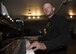 Senior Airman Logan Lingren, 92nd Maintenance Squadron aircraft structural maintenance journeyman, pauses for a photo while playing a grand piano July 24, 2017, in Spokane, Washington. Lingren helped save a man from a knife-wielding attacker in 2016 and was chosen to be in the Portraits of Courage, an Air Force program that highlights Airmen who display exceptional valor. (U.S. Air Force photo/ Airman 1st Class Ryan Lackey)