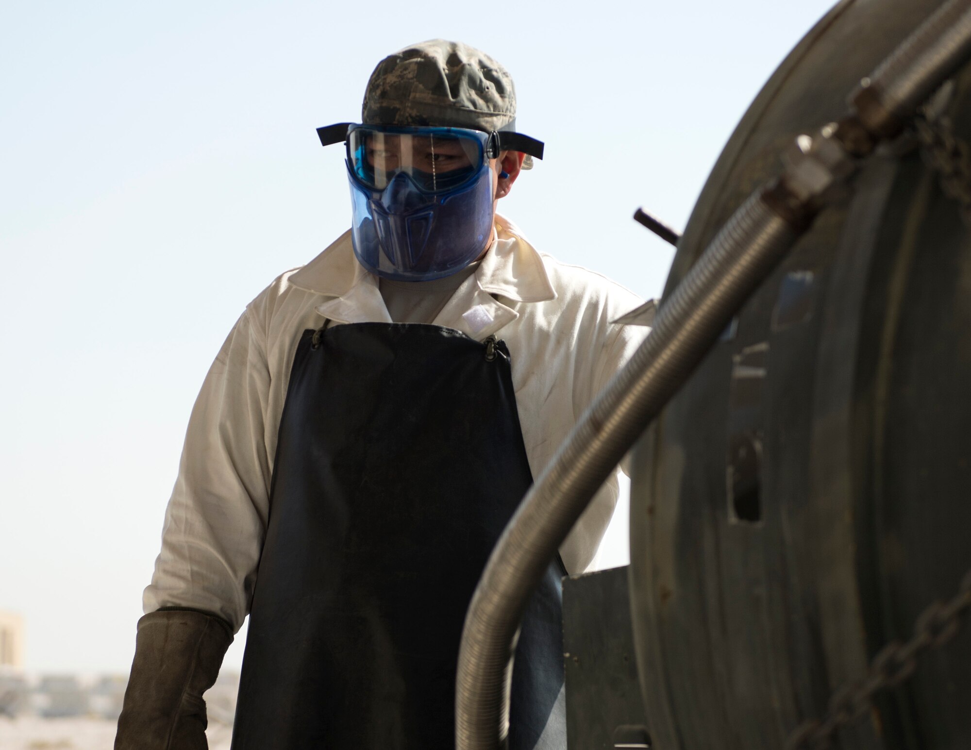 U.S. Air Force Staff Sgt. Kennie Delmo, a cryogenics supervisor with the 379th Expeditionary Logistics Readiness Squadron, Fuels Management Flight, prepares to open a liquid oxygen valve at Al Udeid Air Base, Qatar, Aug. 9, 2017.