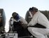 U.S. Air Force Staff Sgt. Kennie Delmo, left, a cryogenics supervisor and Senior Airman Samuel Fallot, a cryogenics journeyman with the 379th Expeditionary Logistics Readiness Squadron, Fuels Management Flight, review their checklist at Al Udeid Air Base, Qatar, Aug. 9, 2017. Delmo and Fallot are preparing a cryogenic sampler to receive a sample of liquid oxygen so it may be transported safety to the lab for quality- testing before it is sent to other locations throughout the U.S. Air Forces Central Command area of responsibility. (U.S. Air Force photo by Tech. Sgt. Amy M. Lovgren)