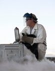 U.S. Air Force Senior Airman Samuel Fallot,a  cryogenics journeyman with the 379th Expeditionary Logistics Readiness Squadron, Fuels Management Flight, gives a thumbs up at Al Udeid Air Base, Qatar, Aug. 9, 2017.  Fallot is watching pounds per square inch levels on the cryogenic sampler where it received a sample of liquid oxygen so it may be transported safely to the lab for quality- testing before it is sent to other locations throughout the U.S. Air Forces Central Command area of responsibility. (U.S. Air Force photo by Tech. Sgt. Amy M. Lovgren)
