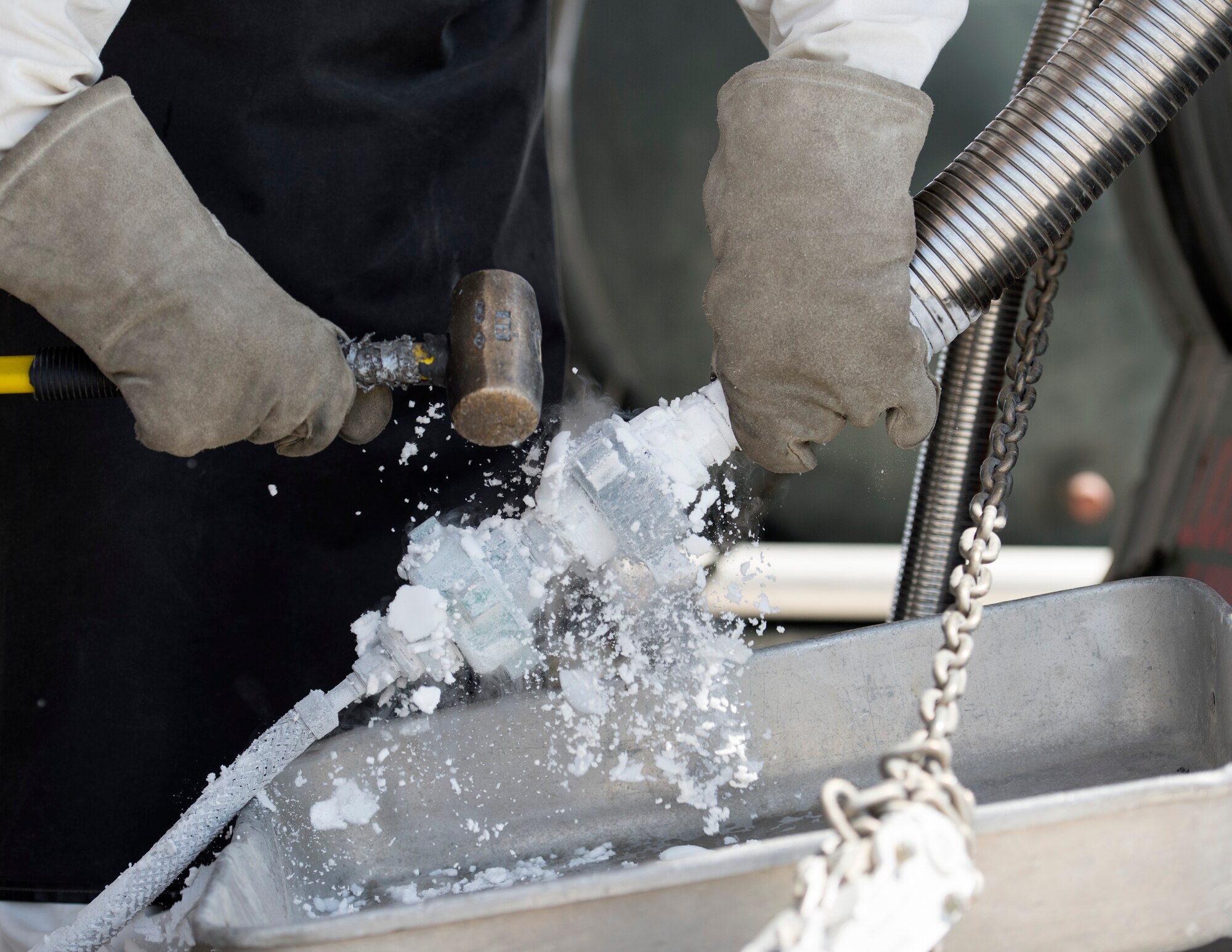 U.S. Air Force Senior Airman Samuel Fallot, a cryogenics journeyman with the 379th Expeditionary Logistics Readiness Squadron, Fuels Management Flight, disconnects a cryogenic sampler from the liquid oxygen tank at Al Udeid Air Base, Qatar, Aug. 9, 2017.