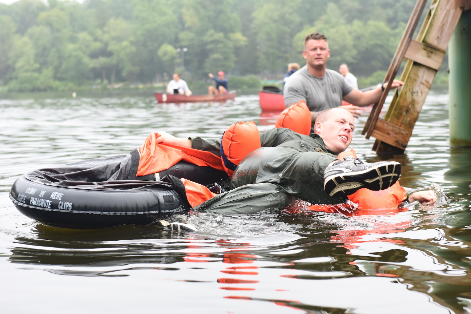 Senior Airman Andrew Hertzog, 193rd Special Operations Group electronics communication systems operator, vacates his one-man life raft after completing a series of checks on the device to ensure familiarization with its operational functions. Hertzog was one of seven 193rd SOG Airmen who participated in the Survival, Evasion, Resistance, and Escape water survival training held at Mount Gretna Lake, Mount Gretna, Pennsylvania, Aug. 12, 2017. Operations Group Airmen are required to complete this training once every three years. (U.S. Air National Guard photo by Tech. Sgt. Claire Behney/Released)