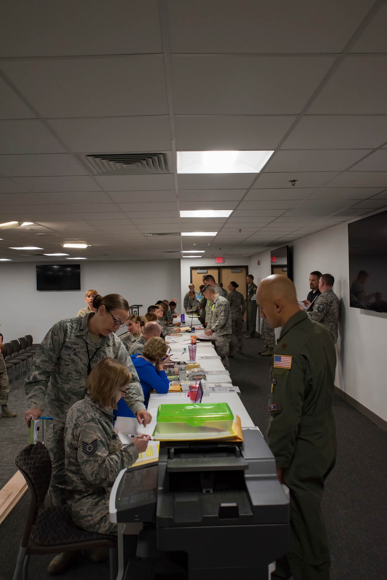 Airmen process through a personnel deployment function line.