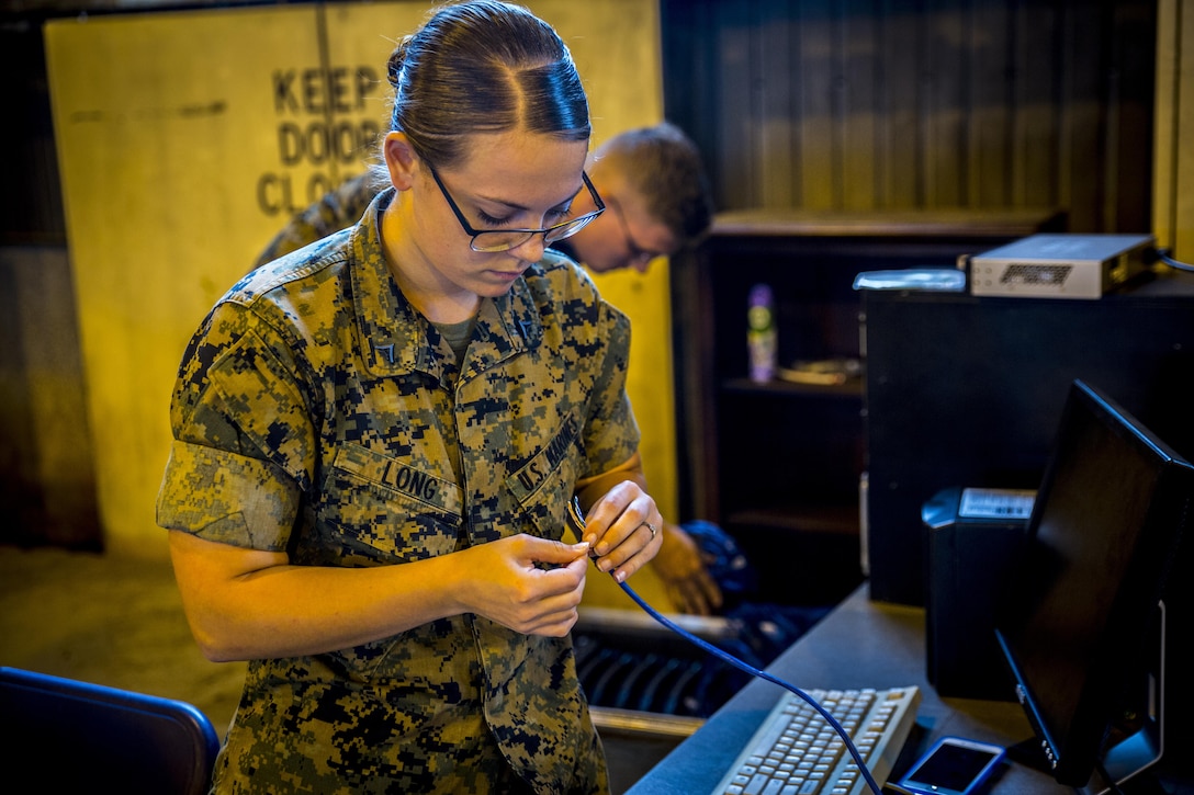 Lance Cpl. Barbara Ann C. Long, an aviation logistics information management systems specialist, sets up computers at Misawa Air Base, Japan, August 10, 2017, signifying the start of exercise Northern Viper 2017. This exercise tests the interoperability and bilateral capability of the Japan Ground Self-Defense Force and U.S. Marine Corps forces to work together and provides the opportunity to conduct realistic training in an unfamiliar environment. Long, a native of Canton, Ohio, is with Marine Light Attack Helicopter Squadron 169, Marine Aircraft Group 39, 3rd Marine Aircraft Wing, currently forward deployed under the Unit Deployment Program with 1st MAW, based on Okinawa, Japan. (U.S. Marine Corps photo by Lance Cpl. Andy Martinez)