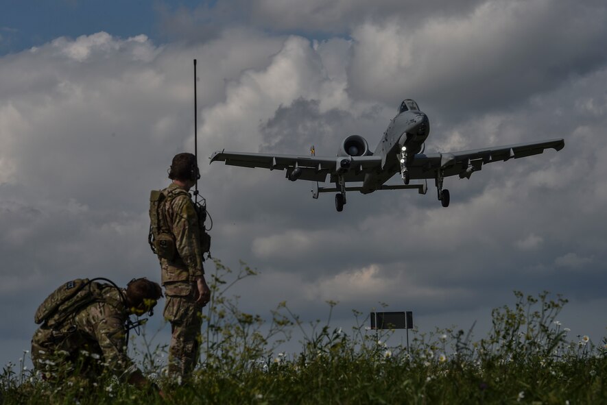 Two combat controllers with the 321st Special Tactics Squadron observe an A-10 Thunderbolt II landing on Jägala-Käravete Highway, Aug. 10, in Jägala, Estonia. A small force of eight Special Tactics combat controllers from the 321st STS surveyed the two-lane highway, deconflicted airspace and exercised command and control on the ground and in the air to land A-10s from Maryland Air National Guard's 104th Fighter Squadron on the highway. (U.S. Air Force photo by Senior Airman Ryan Conroy)