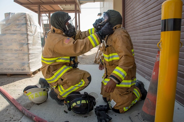 Master Sgt. Aaron Culwell (left), the 386th Expeditionary Civil Engineer squadron fire station one station captain performs a gear safety check of a teammate during a training scenario Friday, August 11, 2017, at the PERSCO building at an undisclosed location in Southwest Asia. (U.S. Air Force photo by 1st Lt. Rashard Coaxum)