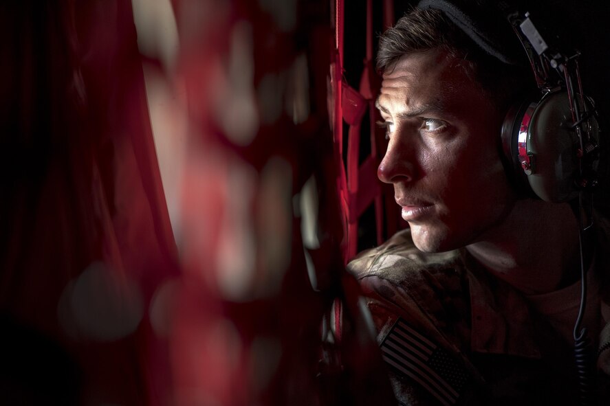 1st Lt. David Schmidt, 71st Rescue Squadron combat systems officer, looks out the window of an HC-130J Combat King II during Stealth Guardian, Aug. 9, 2017, in the skies over the Apalachicola National Forest, Fla. During Stealth Guardian, the 71st RQS worked alongside Airmen from the 325th Fighter Wing to provide airborne mission control and aerial refueling capabilities as well as forward area refueling and rearming points for the F-22 Raptor. (U.S. Air Force photo/ Staff Sgt. Ryan Callaghan)