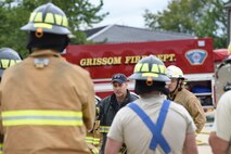 Lt. Lance Long, Indianapolis Fire Department firefighter, explains different hose spraying techniques to Airmen at Grissom Air Reserve Base, Ind., July 8, 2017. The training was held for the 434th Civil Engineer Squadron firefighter’s annual training. (U.S. Air Force photo/ Senior Airman Cali Wetli)