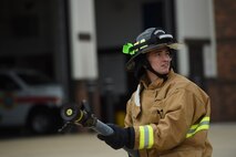 Staff Sgt. Aaron White, 434th Civil Engineer Squadron fire protection journeyman, secures a fire-hose while listening to instructions during a training exercise at Grissom Air Reserve Base, Ind., July 8, 2017. Grissom 434th CES firefighters maintain the same certifications as full time firefighters. (U.S. Air Force photo/ Senior Airman Cali Wetli)