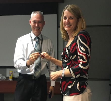 John Williams, division chief, Integration & Operations Division at the Air Force Research Laboratory at Eglin Air Force Base, Fl., presents Toni Ortiz, project manager, U.S. Army Corps of Engineers, Mobile District, with a Munitions Directorate coin, Aug. 4. Ortiz received the coin for her outstanding support in overseeing more than $95 million in various construction projects for the Air Force Research Laboratory.