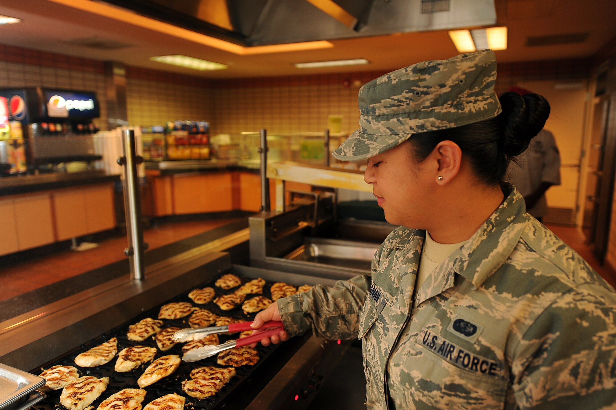 U.S. Air Force Staff Sgt. Jericha Lanaan, a services craftsman assigned to the 254th Force Support Squadron, Guam Air National Guard, grills chicken in preparation for the lunch rush at the Two Seasons dining facility, Aug. 9, 2017, during RED FLAG-Alaska (RF-A) 17-3, on Eielson Air Force Base, Alaska. This is Lanaan’s third TDY to Eielson in support of RED FLAG-Alaska. (U.S. Air Force photo by Staff Sgt. Jerilyn Quintanilla)