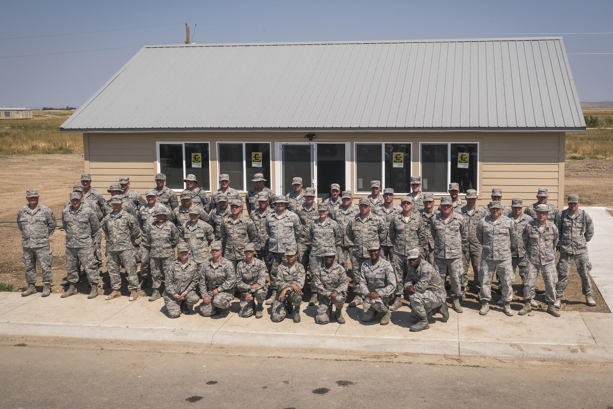 Airmen and soldiers with U.S. National Guard pose for a group photo in Crow Agency, Mont., Aug. 4, 2017. The Illinois Air National Guard’s 182nd Civil Engineer Squadron, augmented by 182nd Force Support Squadron services specialists, 182nd Medical Group medics and soldiers with the Montana Army National Guard’s 230th Vertical Engineer Company, helped build homes for Crow Nation veterans as part of the Department of Defense’s Innovative Readiness Training civil-military relations program. (U.S. Air National Guard photo by Tech. Sgt. Lealan Buehrer)