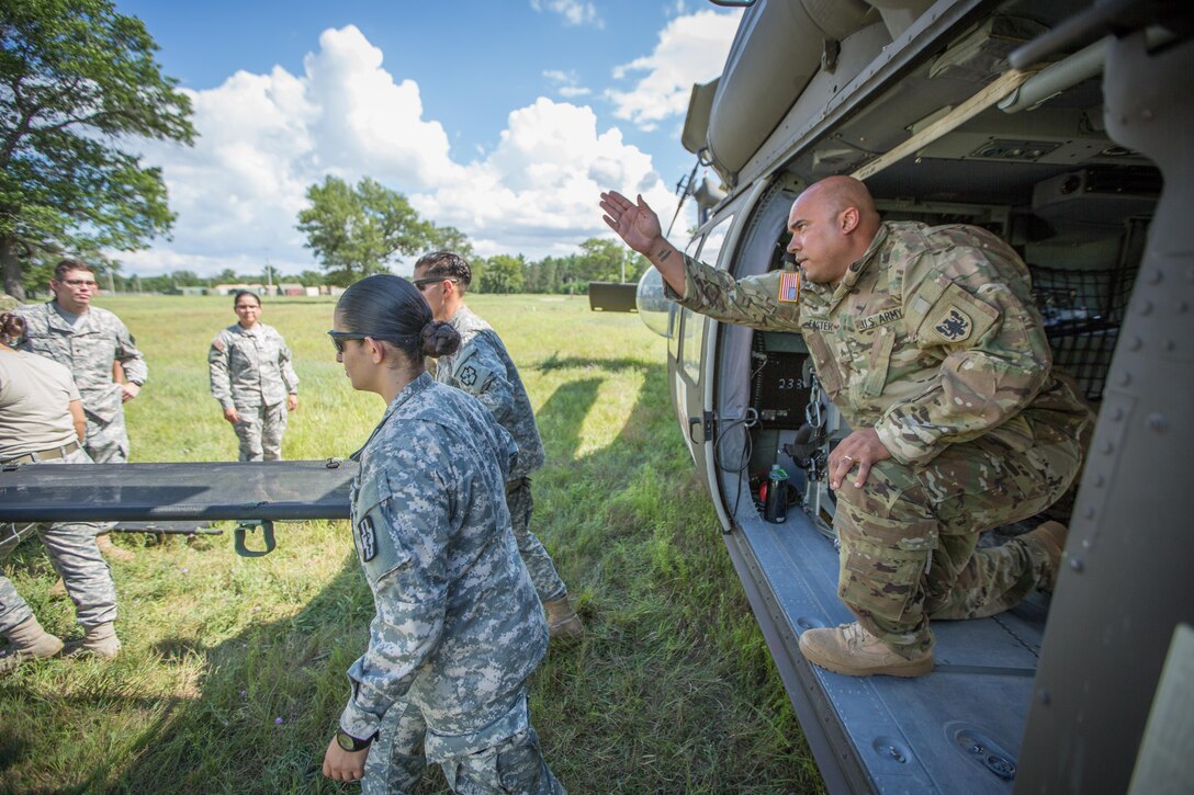 U.S. Army Reserve Soldiers from the 328th Combat Support Hospital (CSH) and 349th CSH practice hot-load litter techniques during Combat Support Training Exercise (CSTX) 86-17-02 at Fort McCoy, Wis., August 10, 2017. Hot-load litter techniques involve actual simulated casualties being carried on the litter. CSTX includes more than 12,000 service members from the Army, Navy, Air Force and Marine Corps as well as from six countries. CSTX is a large-scale training event where units experience tactical training scenarios specifically designed to replicate real-world missions. (U.S. Army Reserve photo by Spc. John Russell/Released)