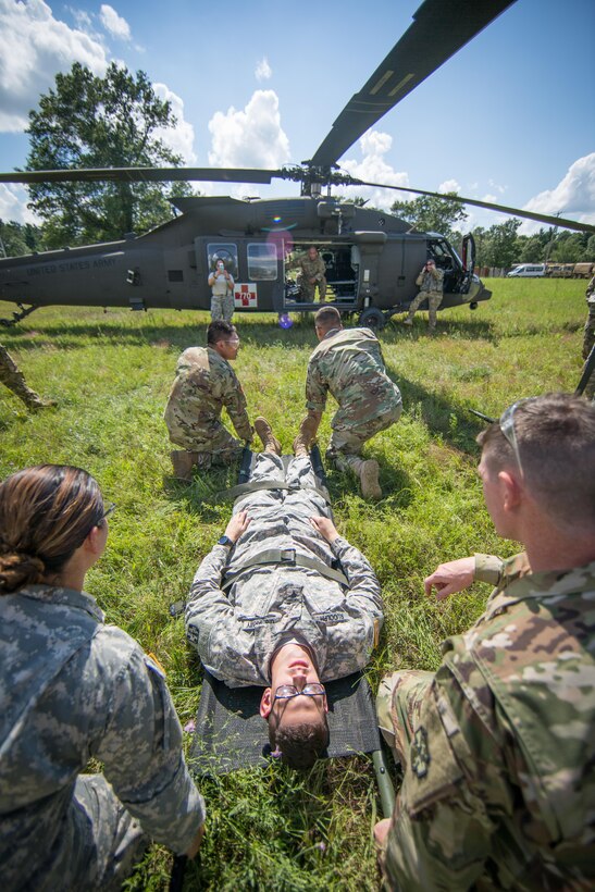 U.S. Army Reserve Soldiers from the 328th Combat Support Hospital (CSH) and 349th CSH practice hot-load litter techniques during Combat Support Training Exercise (CSTX) 86-17-02 at Fort McCoy, Wis., August 10, 2017. Hot-load litter techniques involve actual simulated casualties being carried on the litter. CSTX includes more than 12,000 service members from the Army, Navy, Air Force and Marine Corps as well as from six countries. CSTX is a large-scale training event where units experience tactical training scenarios specifically designed to replicate real-world missions. (U.S. Army Reserve photo by Spc. John Russell/Released)