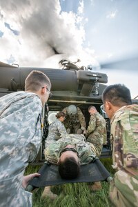 U.S. Army Reserve Soldiers from the 328th Combat Support Hospital (CSH) and 349th CSH practice hot-load litter techniques during Combat Support Training Exercise (CSTX) 86-17-02 at Fort McCoy, Wis., August 10, 2017. Hot-load litter techniques involve actual simulated casualties being carried on the litter. CSTX includes more than 12,000 service members from the Army, Navy, Air Force and Marine Corps as well as from six countries. CSTX is a large-scale training event where units experience tactical training scenarios specifically designed to replicate real-world missions. (U.S. Army Reserve photo by Spc. John Russell/Released)