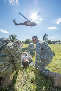 U.S. Army Reserve Soldiers from the 328th Combat Support Hospital (CSH) and 349th CSH practice hot-load litter techniques during Combat Support Training Exercise (CSTX) 86-17-02 at Fort McCoy, Wis., August 10, 2017. Hot-load litter techniques involve actual simulated casualties being carried on the litter. CSTX includes more than 12,000 service members from the Army, Navy, Air Force and Marine Corps as well as from six countries. CSTX is a large-scale training event where units experience tactical training scenarios specifically designed to replicate real-world missions. (U.S. Army Reserve photo by Spc. John Russell/Released)