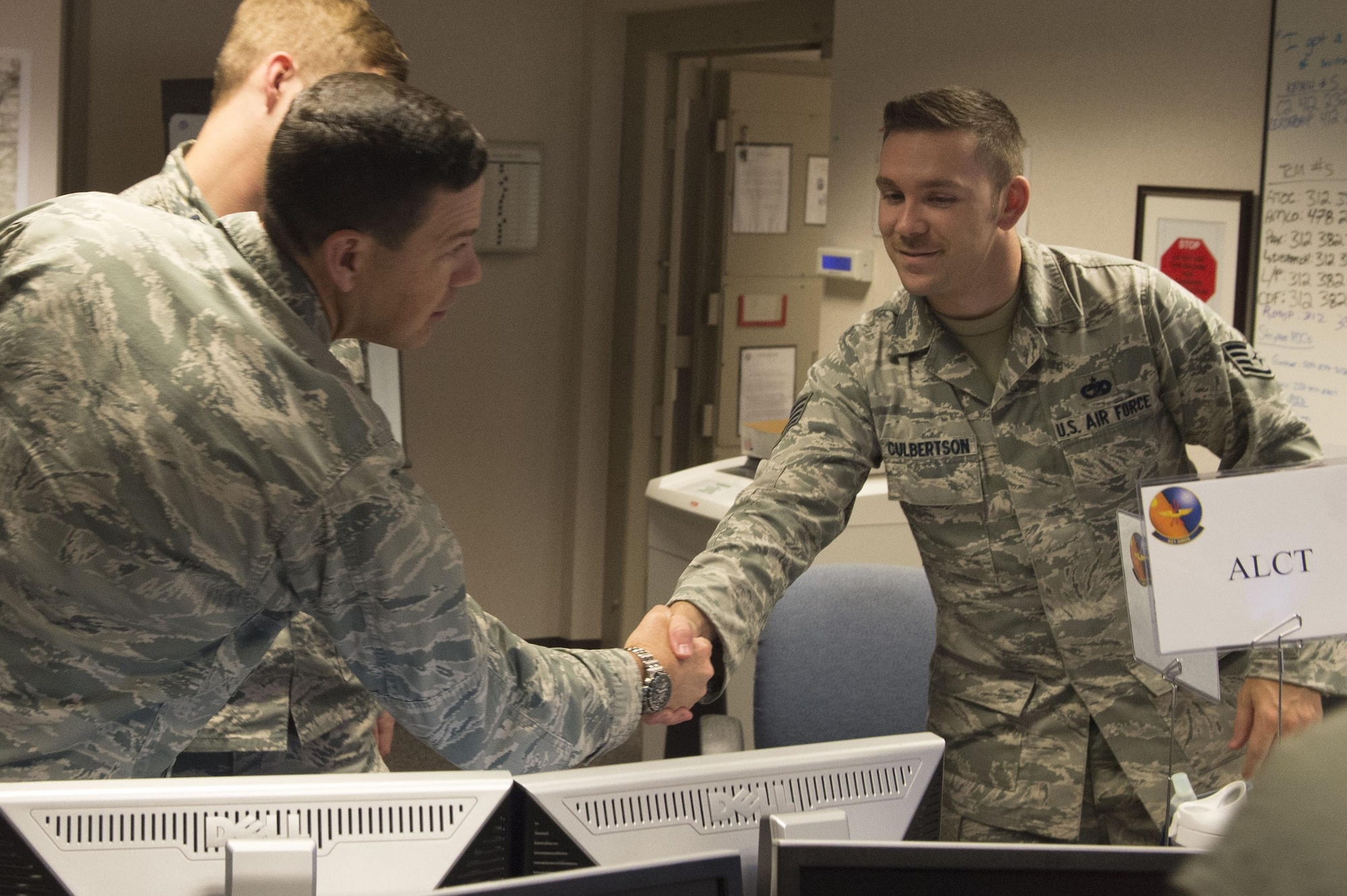 Brig. Gen. Stephen W. Oliver, U.S. Air Force Expeditionary Center vice commander, shakes the hand of Staff Sgt.Talon Culbertson, during a tour of the 621st Air Mobility Operations Squadron during their participation in Exercise Mobility Guardian at Joint Base McGuire-Dix-Lakehurst, N.J., August 1, 2017. The exercise is designed to enhance the capabilities of AMC Airmen by preparing them to succeed in the dynamic threat environments. (U.S. Air Force photo by Tech. Sgt. Gustavo Gonzalez/RELEASED)