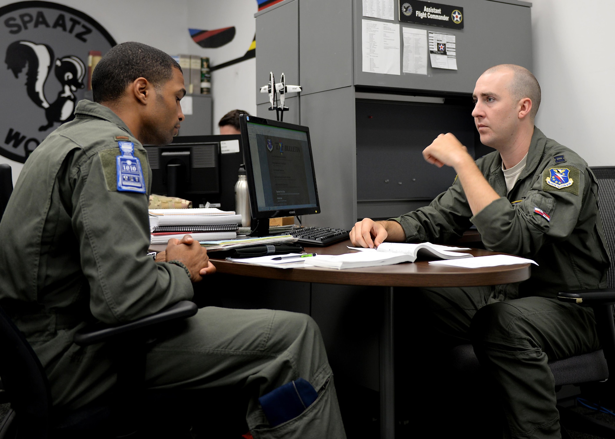 Second Lt. Marcos Marrero-Disla, a 41st Flying Training Wing student pilot, and Capt. Calogero San Filippo, the 41st FTS Assistant Flight Commander, run through a flight plan Aug. 8, 2017, on Columbus Air Force Base, Mississippi. Talking through flight plans and scenarios helps pilots develop solutions and prepare them for creating real flight plans. (U.S. Air Force photo by Airman 1st Class Keith Holcomb)