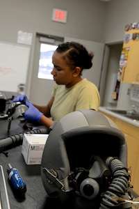 Airman 1st Class Rachelle Allen, a 14th Operations Support Squadron aircrew flight equipment technician, cleans a pilot’s helmet Aug. 8, 2017, on Columbus Air Force Base, Mississippi. Without maintenance the helmets can malfunction, stopping oxygen from going to the pilot and causing hypoxia. (U.S. Air Force photo by Airman 1st Class Keith Holcomb)