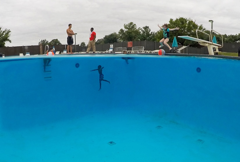 Children swim and dive in the deep end of the Joint Base Andrews pool.