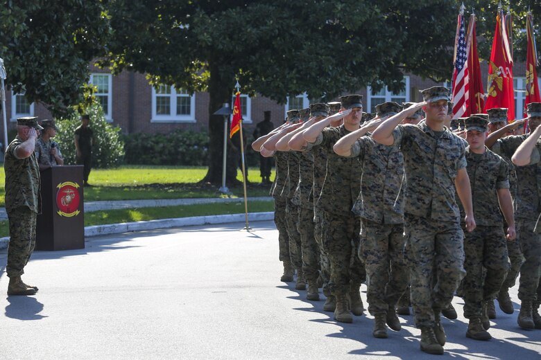 Col. David Owen salutes Marines for a pass in review at the conclusion of a redesignation ceremony, during which II Marine Expeditionary Force Headquarters Group was renamed II MEF Information Group at Camp Lejeune, N.C., July 21, 2017. The unit’s redesignation to II MIG is the first visible action complimentary to the forthcoming capabilities that support the Commandant’s priorities to modernize the force and develop increased capability in the information environment.