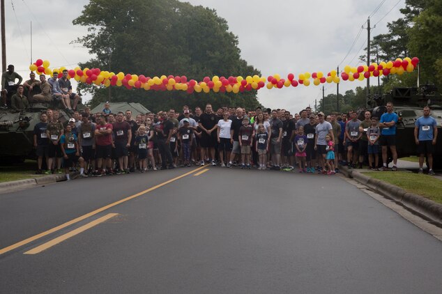 Run to Remember participants pose for a group photo before beginning the race at Camp Lejeune, N.C. Aug 5, 2017. The run is held every first Saturday of August in honor of Sgt. Lucas Pyeatt, a cryptologic linguist killed in action during Operation Enduring Freedom, February 2011, and other service members killed in action.