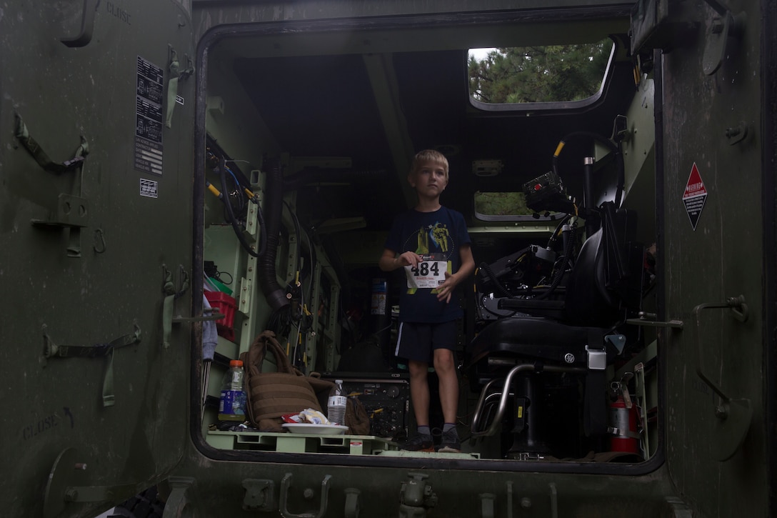 A boy tours a light armored vehicle during the Run to Remember memorial run at Camp Lejeune, N.C. Aug 5, 2017. The run is held every first Saturday of August in honor of Sgt. Lucas Pyeatt, a cryptologic linguist killed in action during Operation Enduring Freedom, February 2011, and other service members killed in action.