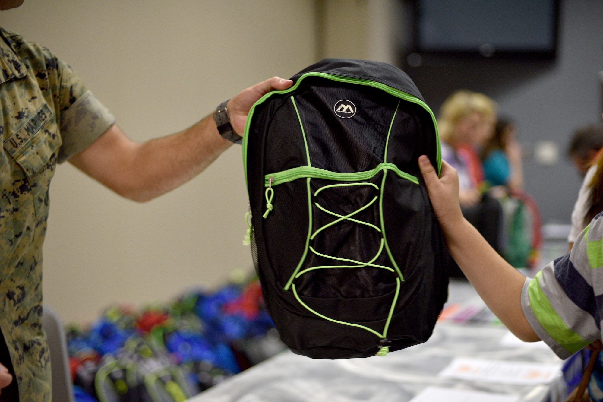 asp
U.S. Marine Sgt. Nathen Gruden, 312th Training Squadron instructor, gives a free backpack full of school supplies to a child during Operation Back to School in the Event Center on Goodfellow Air Force Base, Texas, Aug. 10, 2017. The backpack included pencils, pens, notebooks and crayons. (U.S. Air Force photo by Airman 1st Class Randall Moose/Released)