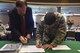 Howard Taylor, San Angelo Museum of Fine Arts director, and U.S. Air Force Col. Ricky Mills, 17th Training Wing commander, sign a STARBASE memorandum at the San Angelo Museum of Fine Arts, San Angelo, Texas, Aug. 11, 2017. The memorandum signaled the official STARBASE agreement between San Angelo and Goodfellow Air Force Base. The STARBASE curriculum focuses on exposing youth to innovative hands-on activities in science, technology, engineering and mathematics based on the physics of flight. (U.S. Air Force photo by Airman 1st Class Chase Sousa/Released)