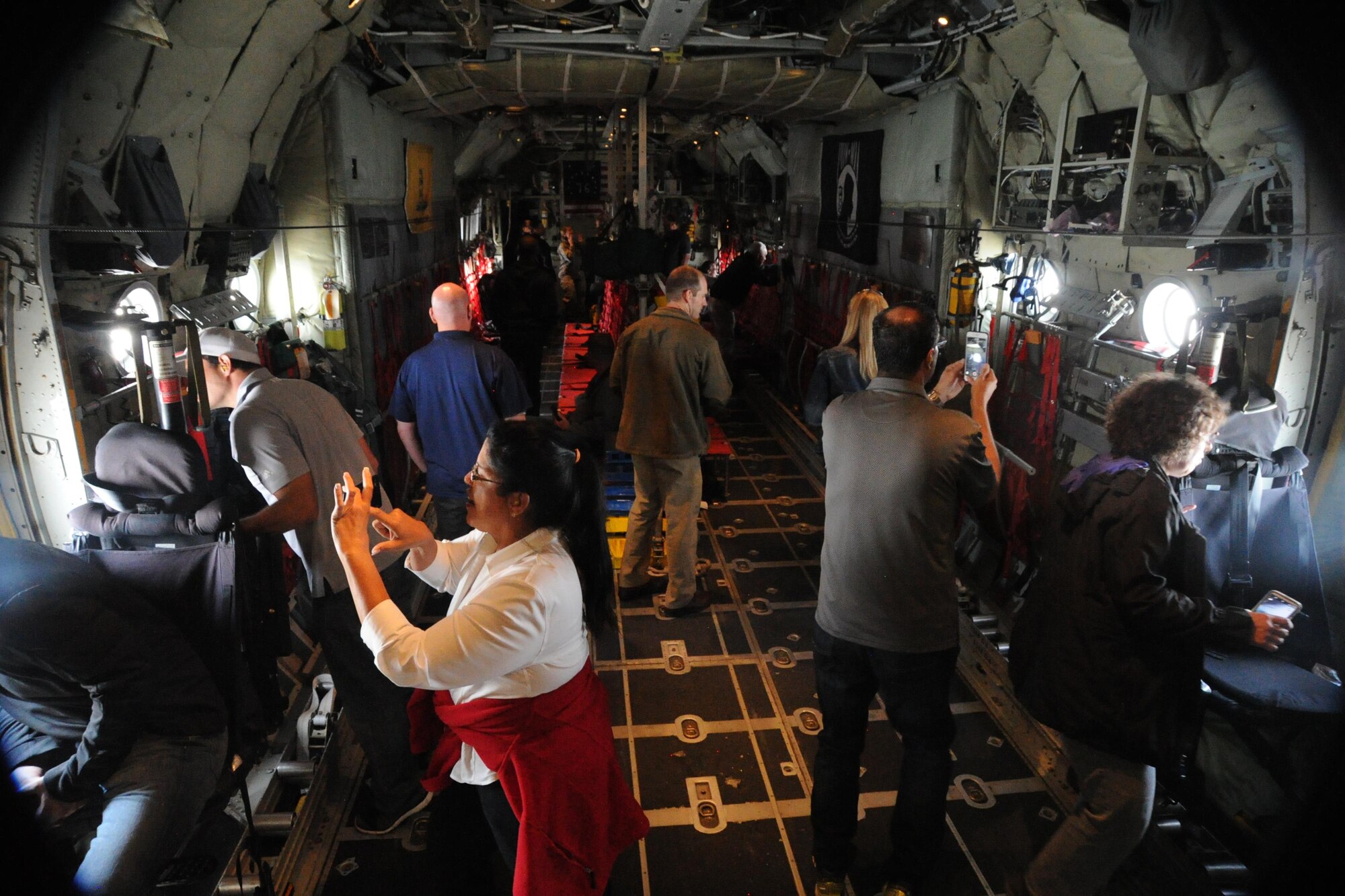 Civilian employers flying on board a C-130 Hercules orientation flight take photos and look out windows of the aircraft during the 302nd Airlift Wing’s annual Employer Appreciation Day hosted at Peterson Air Force Base, Colo., Aug. 4 2017.