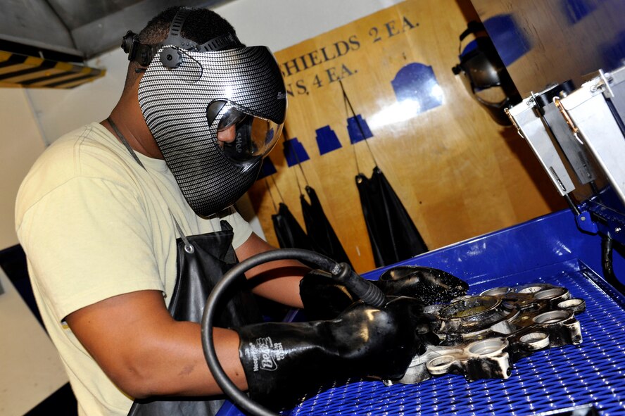 Airman 1st Class Jonathan Edwards, 56th Component Maintenance Squadron hydraulics journeyman, cleans an A-10 Thunderbolt landing gear brake piece at Luke Air Force Base, Ariz. August 8, 2017. Edwards used a highly corrosive liquid to clean the oil and dirt of the break piece.(U.S. Air Force photo/Airman 1st Class Pedro Mota)