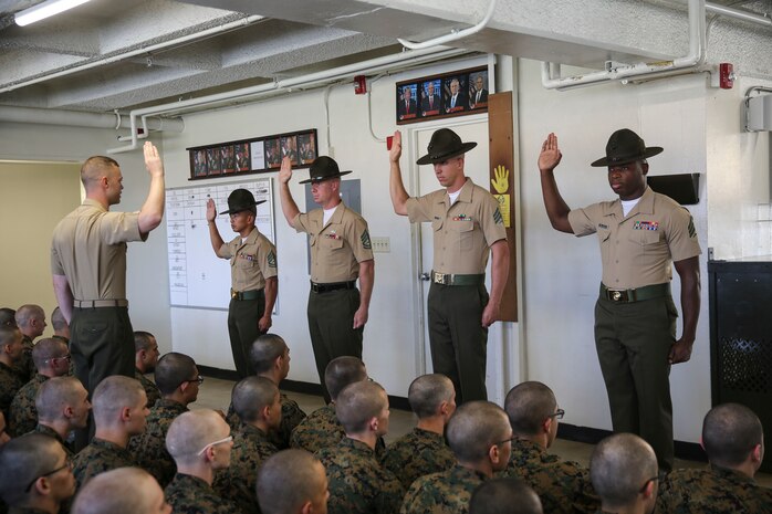 Drill instructors with Hotel Company, 2nd Recruit Training Battalion, recite the drill instructor creed during pick up at Marine Corps Recruit Depot San Diego, Aug. 11.