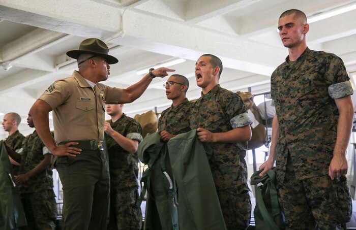A drill instructor from Hotel Company, 2nd Recruit Training Battalion, instructs a recruit to respond louder during pick up at Marine Corps Recruit Depot San Diego, Aug. 11.
