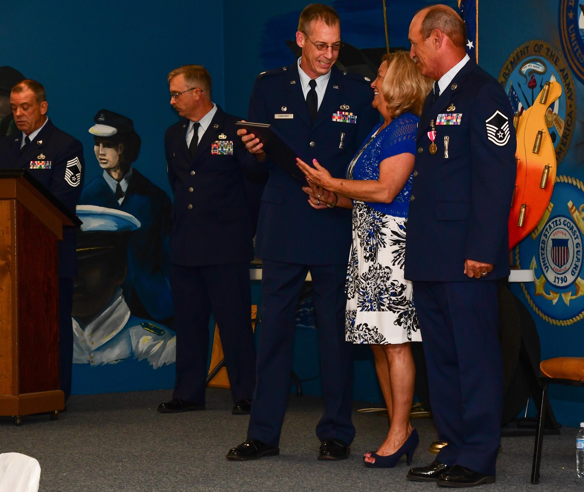 Lt. Col. Warren Crabtree, presents a certificate of appreciation to Teresa Cunefare, the wife of Master Sgt. Johnny Cunefare, a Munitions Systems Craftsman assigned to the 307th Maintenance Squadron, during a retirement ceremony Aug. 5, 2017 at the Veterans of Foreign Wars Post 5951, Bossier City, La.