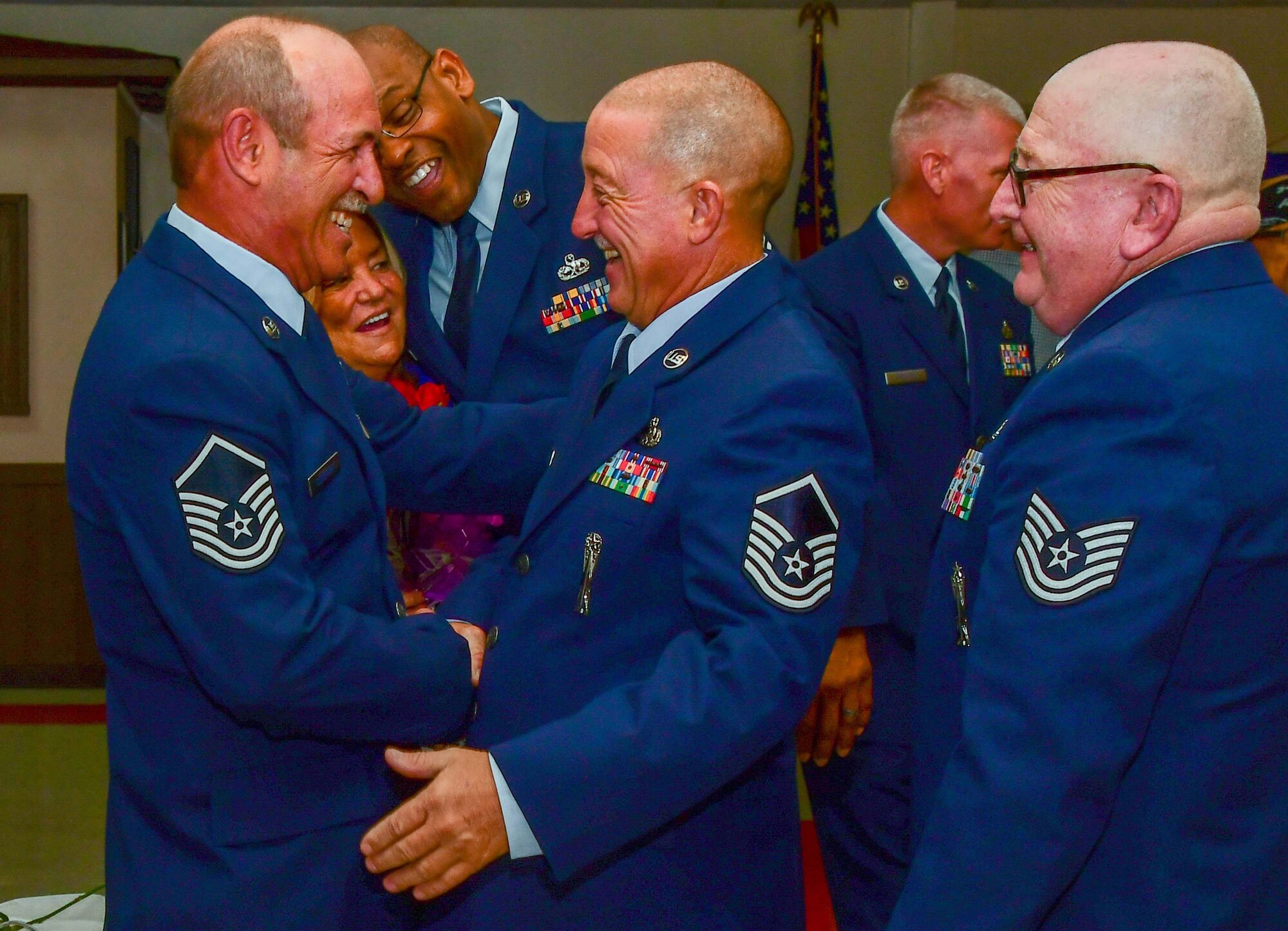 Master Sgt. Johnny Cunefare (left), is congratulated by Master Sgt. William Martin (center) and Tech. Sgt. John Carter (right) after Cunefare’s retirement ceremony Aug. 5, 2017 at the Veterans of Foreign Wars Post 5951, Bossier City, La.