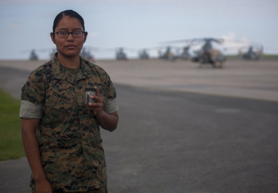 Lance Cpl. Jeanette E. Fernando holds a jar of sand taken from her trip to Iwo Jima, August 1, 2017, at Marine Corps Air Station Futenma, Okinawa, Japan. Fernando and other Marines in her squadron were given the opportunity to revisit the battlegrounds at which Fernando's grandfather, a Navajo Code Talker, fought during World War II. Fernando is an airframe mechanic assigned to Marine Light Attack Helicopter Squadron 169, Marine Aircraft Group 39, 3rd Marine Aircraft Wing, currently on a unit deployment program with 1st MAW based in Okinawa, Japan. (U.S. Marine Corps photo by Lance Cpl. Andy Martinez)