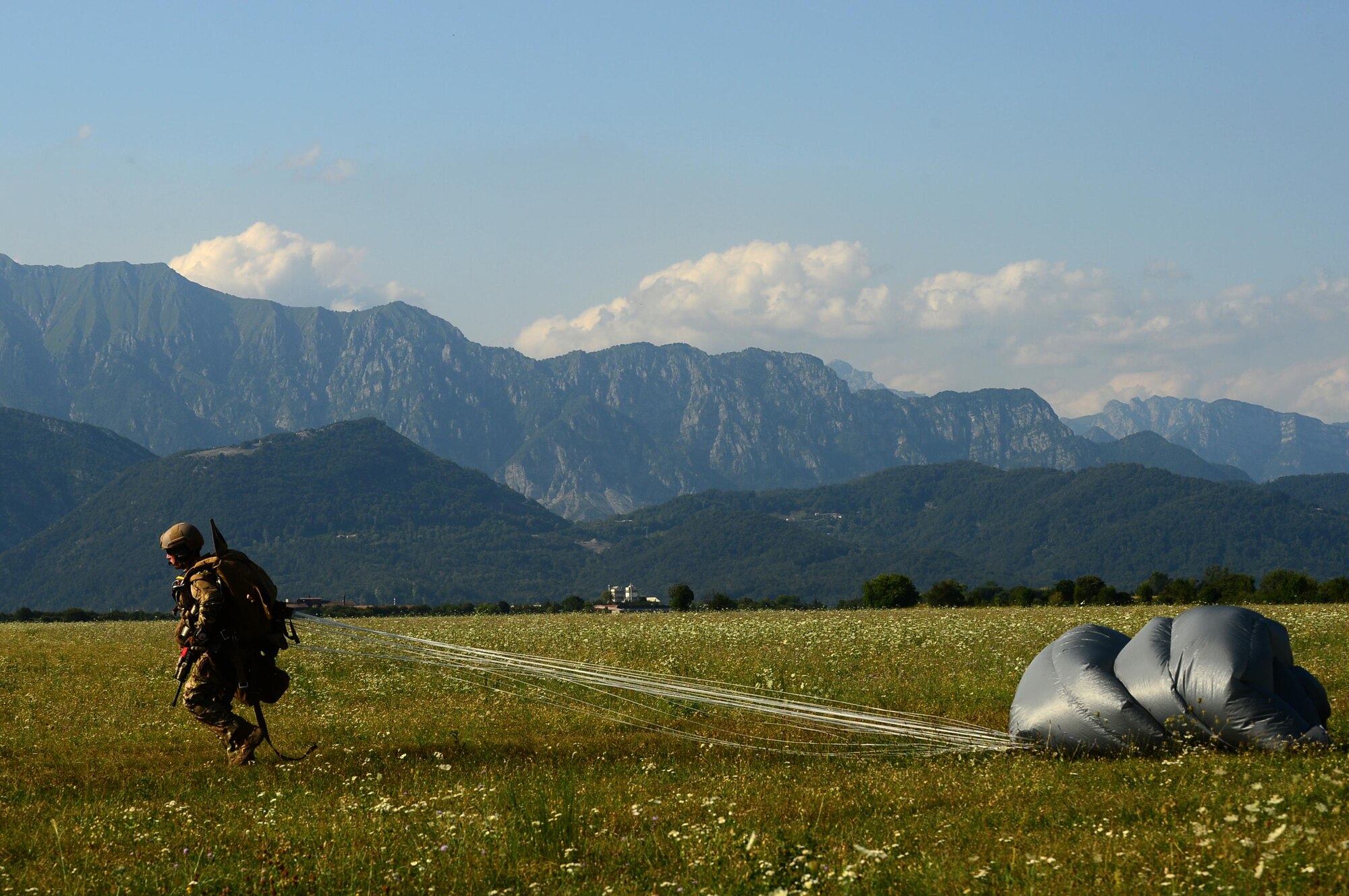 An Airman assigned to the 57th Rescue Squadron regroups with the rest of his team after a freefall jump during exercise Ares Shadow near Aviano, Italy, Aug. 9. The 57th RQS is scheduled to move to Aviano Air Base in the summer of 2018. (U.S. Air Force photo/Airman 1st Class Eli Chevalier)