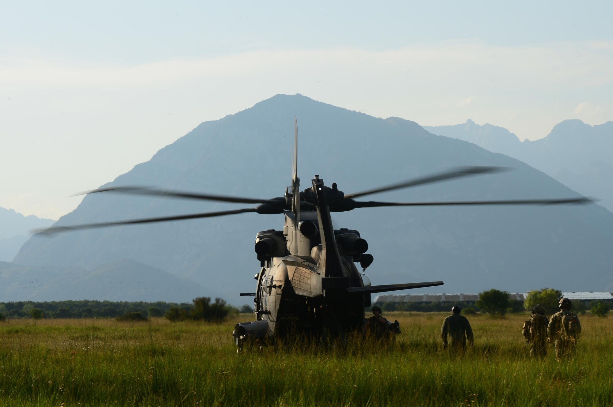 An Italian Air Force HH-101 Caesar extracts a team of Guardian Angels assigned to the 57th Rescue Squadron, and their simulated rescued pilot, during exercise Ares Shadow near Aviano, Italy, Aug. 9. The exercise marked the first time the 57th RQS worked with the Italian air force. (U.S. Air Force photo/Airman 1st Class Eli Chevalier)